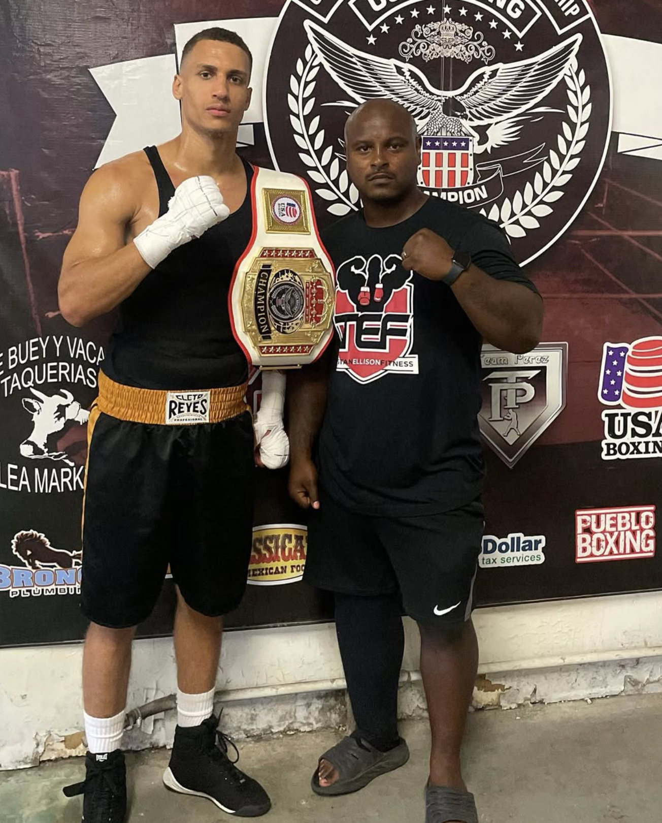 David Kasindi Kongo with Coach Tristan Ellison holding championship belt at Team Tef Boxing